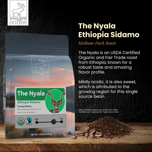 The Nyala Ethiopia Sidamo organic medium-dark roast coffee bag with coffee beans and grounds on wooden surface