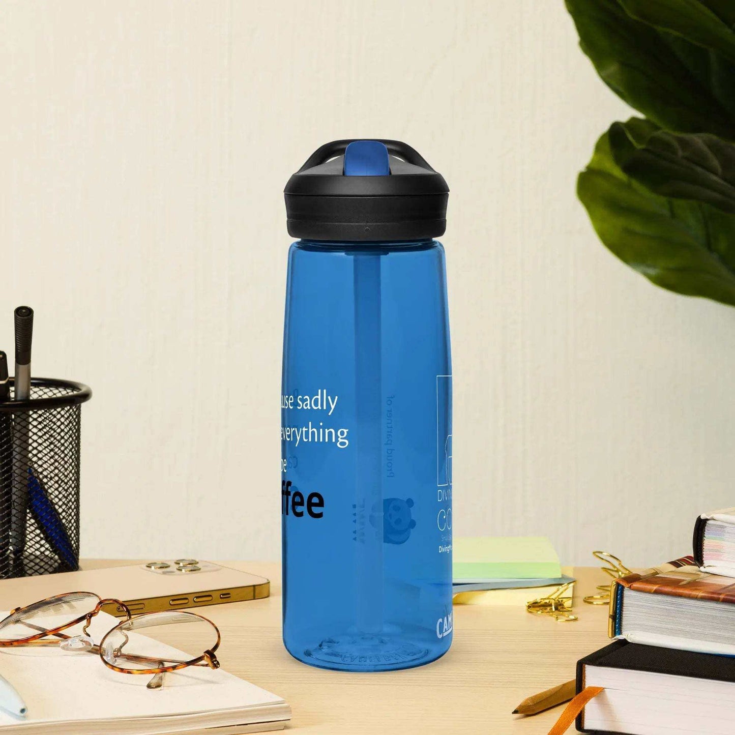 Blue CamelBak Eddy+ water bottle made from 50% recycled plastic with spill-proof lid and bite valve on desk