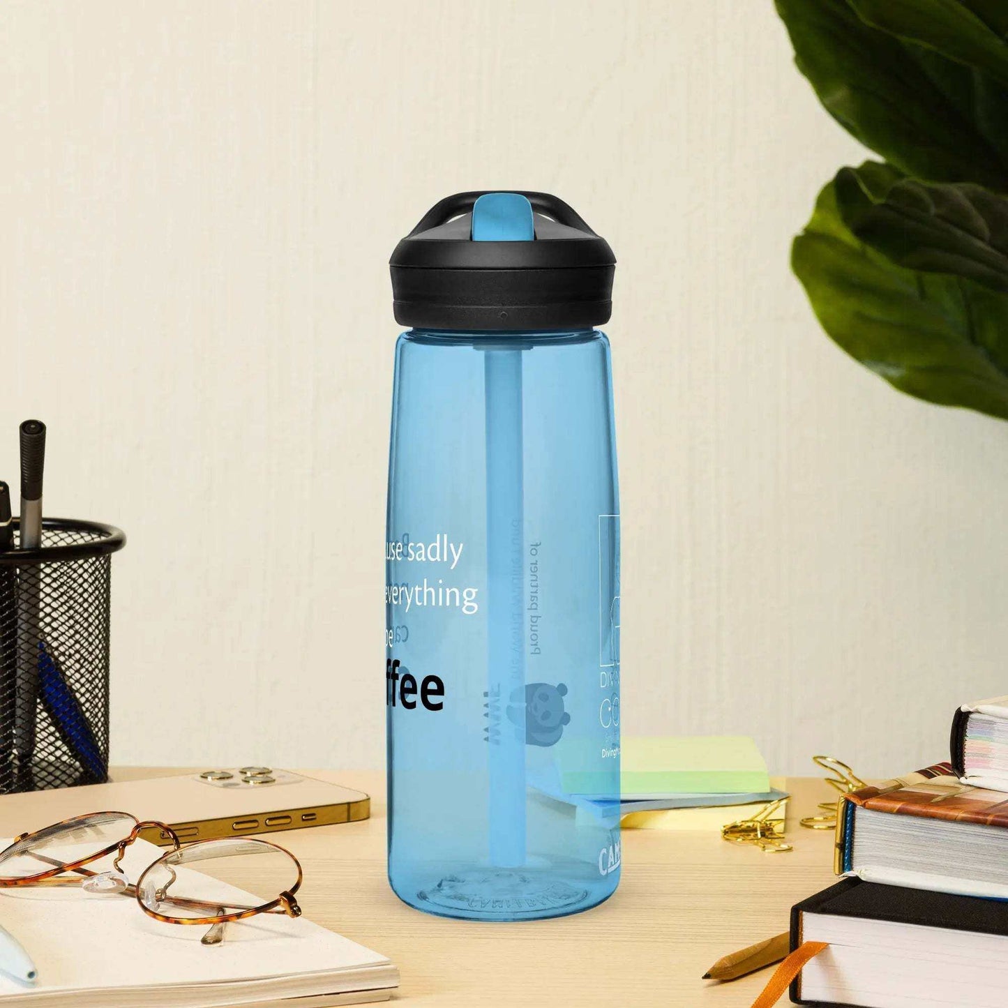 Blue CamelBak Eddy+ sports water bottle with spill-proof lid on desk with glasses and stationery