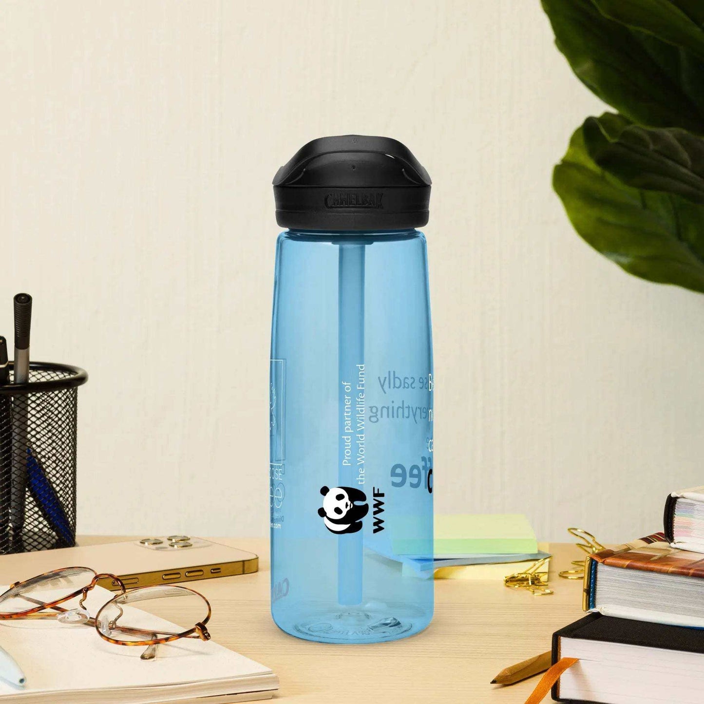Blue DMC CamelBak Eddy+ Sports Water Bottle made from 50% recycled plastic with spill-proof lid and bite valve on desk